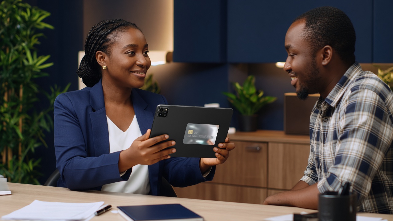 Loan officer completing Ghana Card KYC with a customer